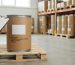 Sealed drum of standardized extract powder with gloved hand holding a checklist, representing commercial MOQ.